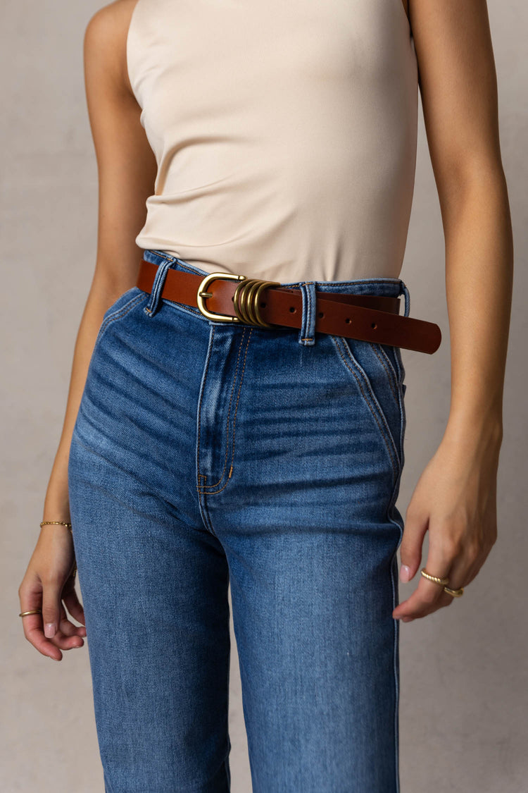model wearing one inch brown belt with gold hardware 