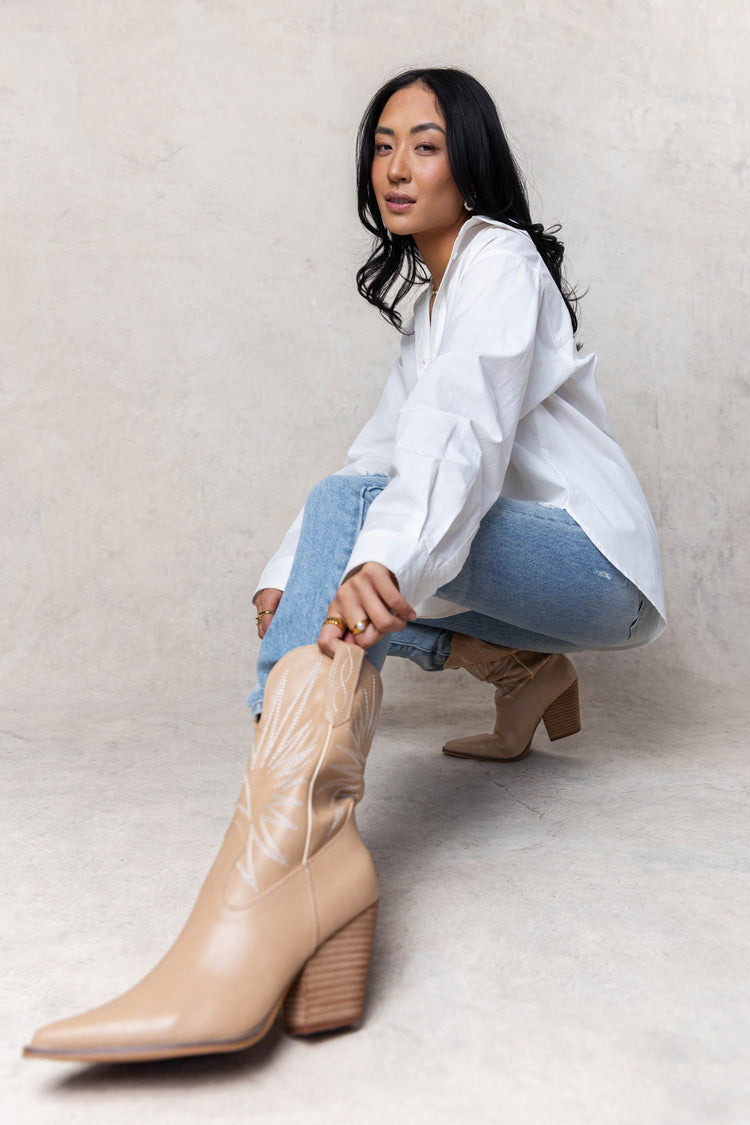beige cowgirl boots with white stitching