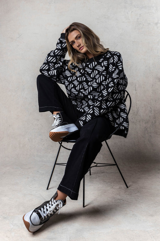 printed sweater with black cargo pants