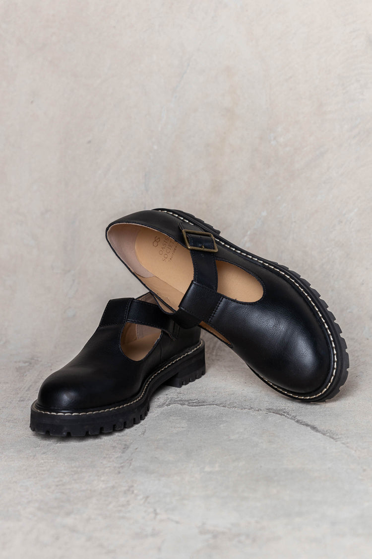 black loafers with buckle detail