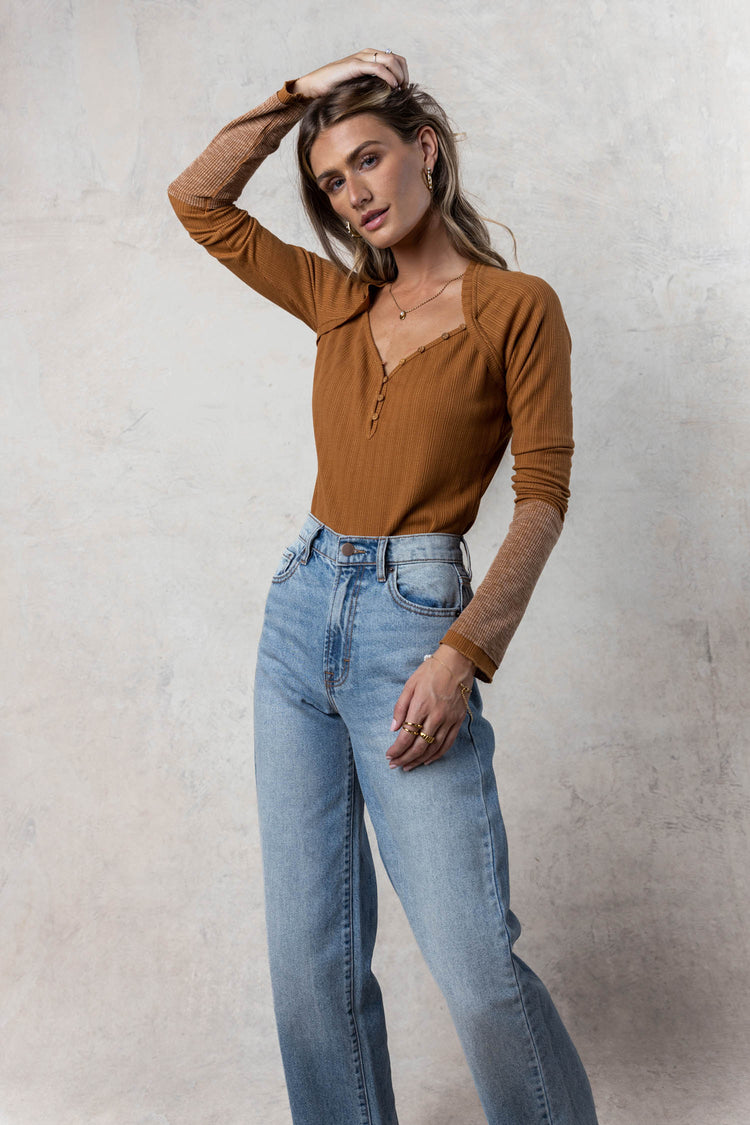 model wearing button top with wide leg denim