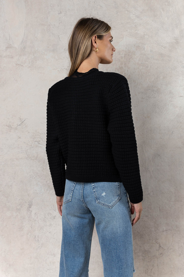 knit black sweater with long sleeves