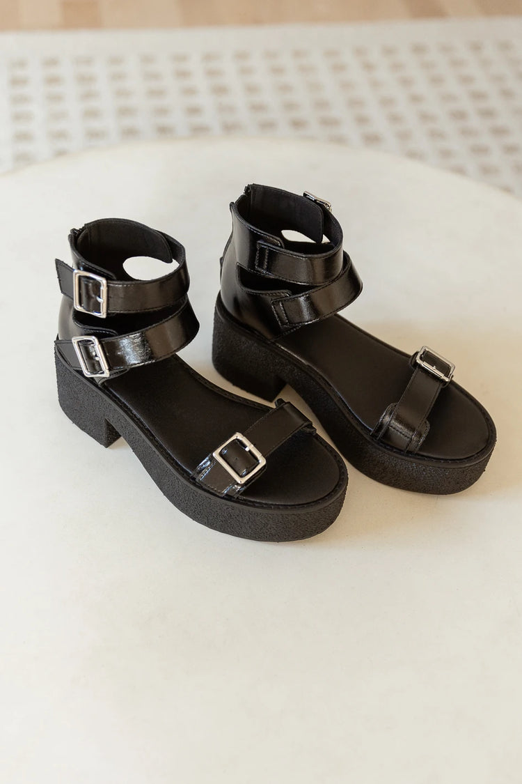black platform sandals with silver buckle details