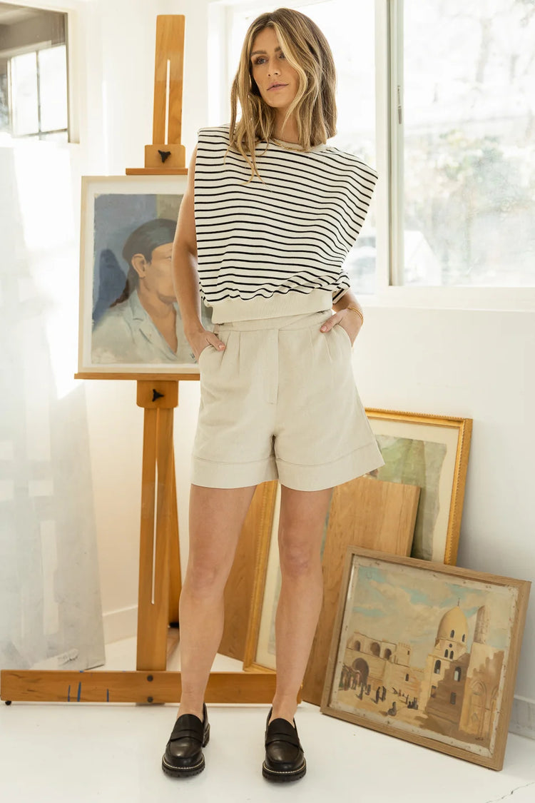 Striped top paired with shorts and black mules 