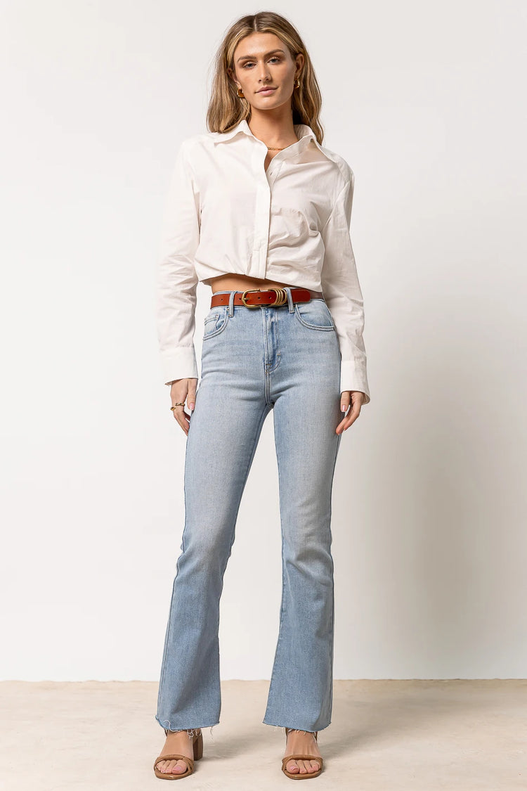white button up paired with light wash denim