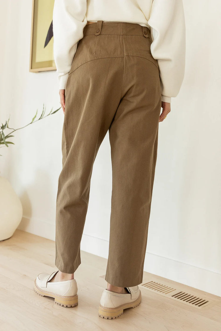 khaki trousers paired with cream loafers