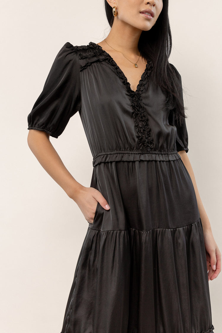 v-neck black dress with ruffle detail