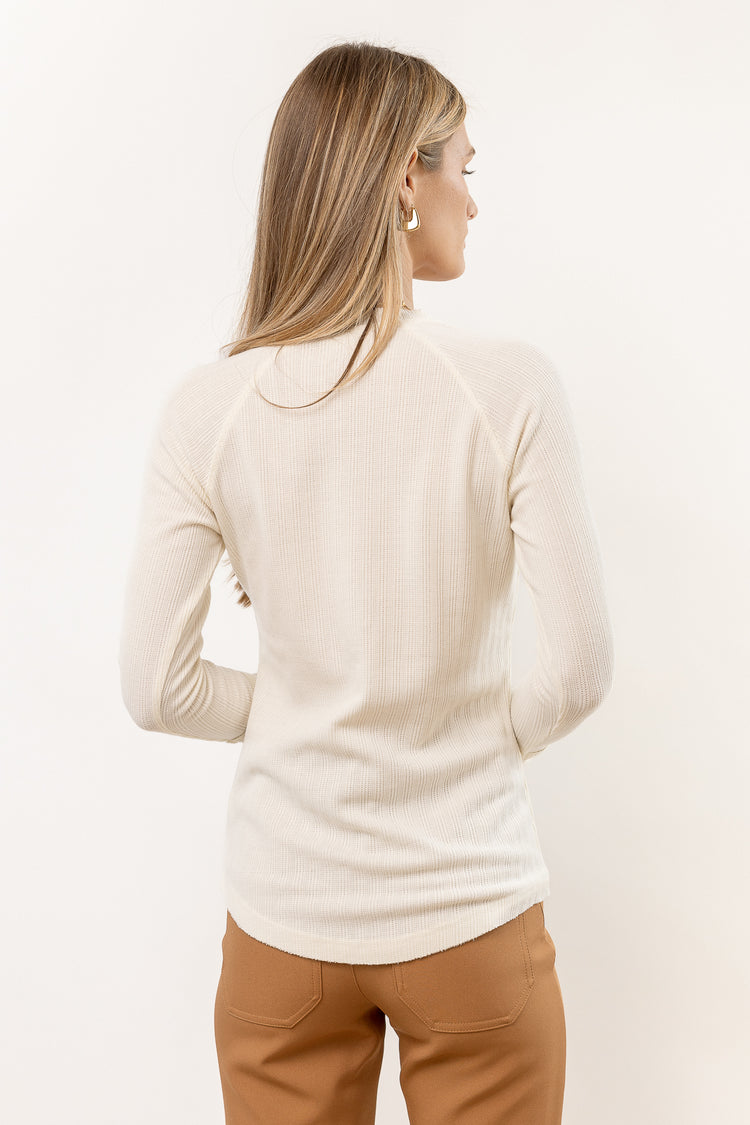 long sleeve cream shirt paired with tan pants