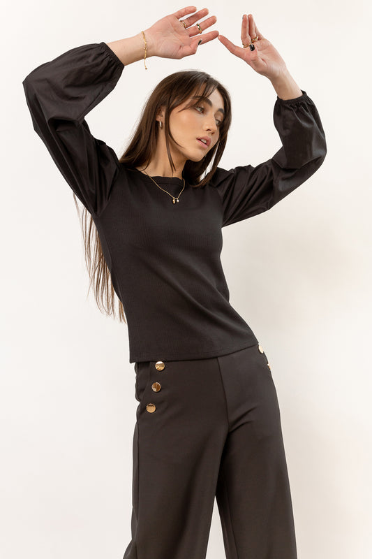 long sleeve black shirt paired with black wide leg pants