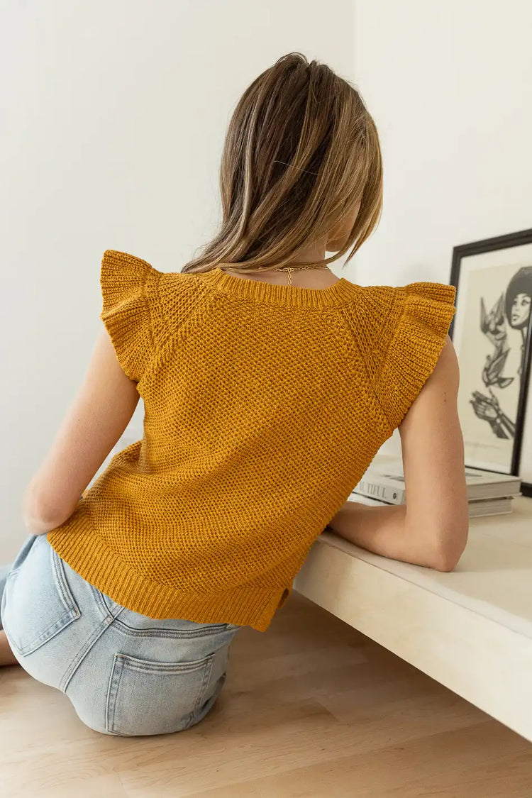 backside  of sweater top in mustard 