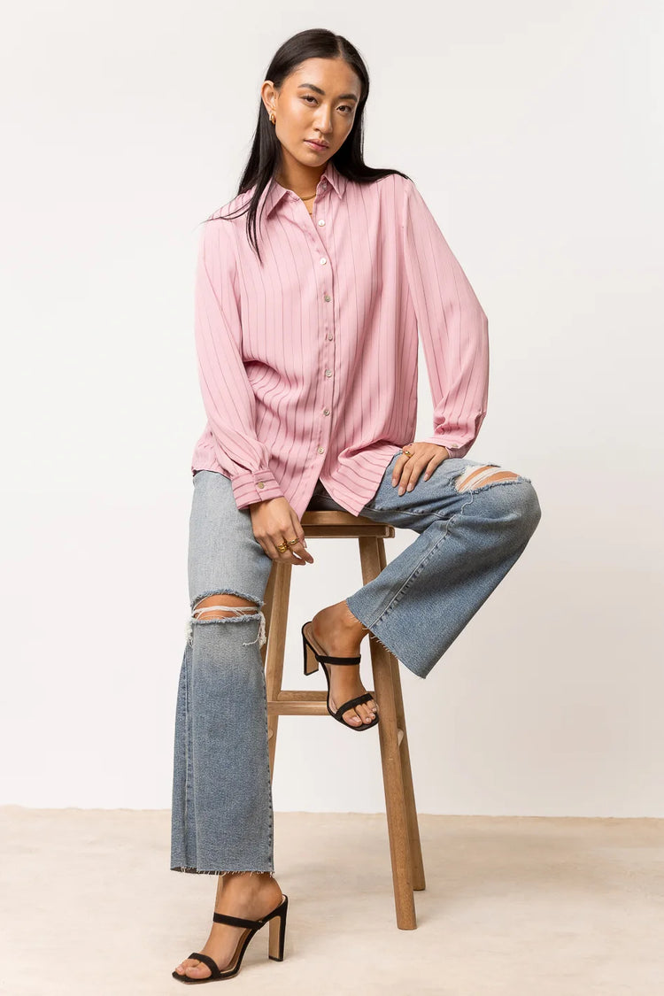 long sleeve pink button down paired with black heel