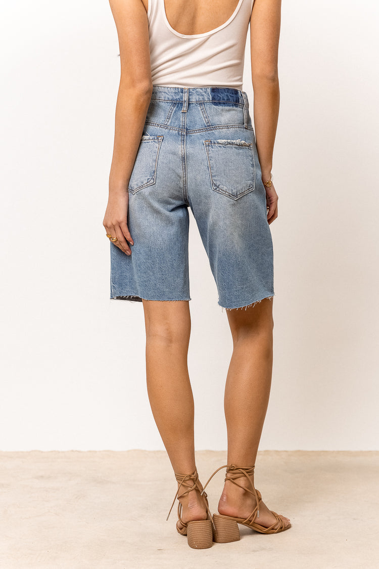 medium wash wide leg knee length denim shorts paired with sandals