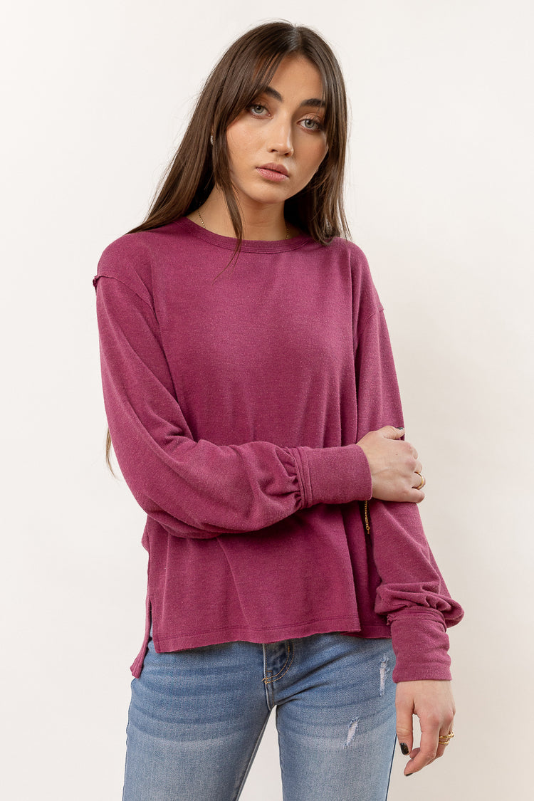 magenta long sleeve shirt paired with denim