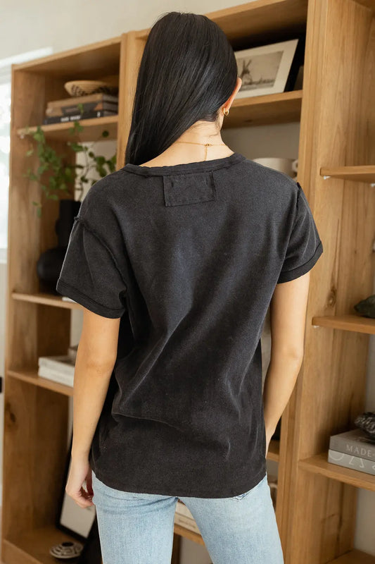 black short sleeve top paired with light wash denim