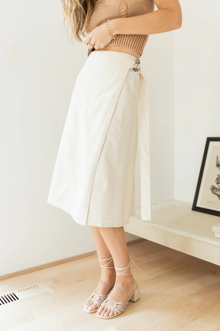 ivory midi skirt paired with cream heeled sandals