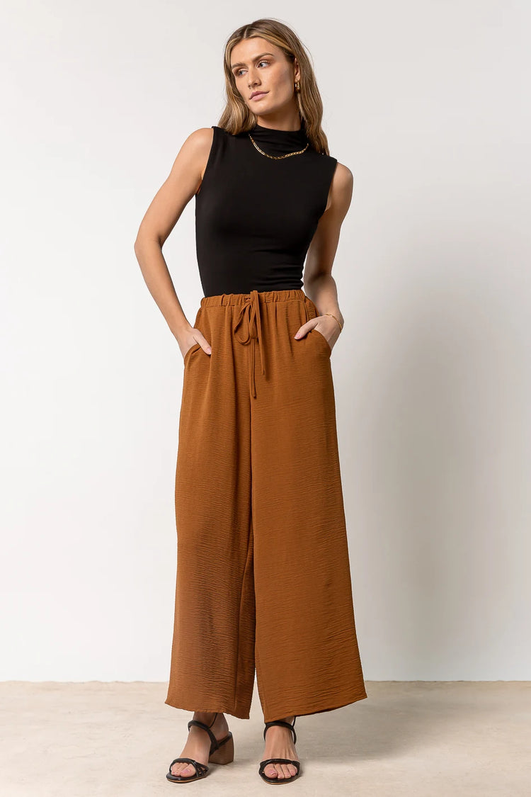 brown wide leg pants paired with black bodysuit