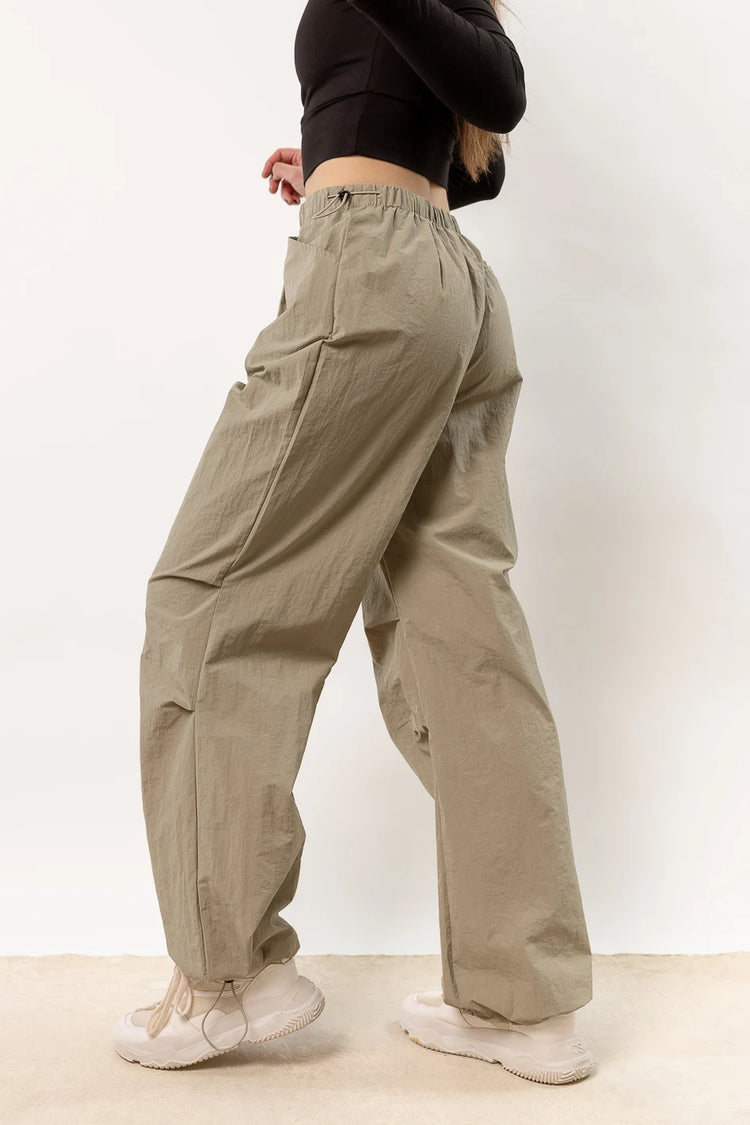 olive parachute pants with waist and ankle cinch detail