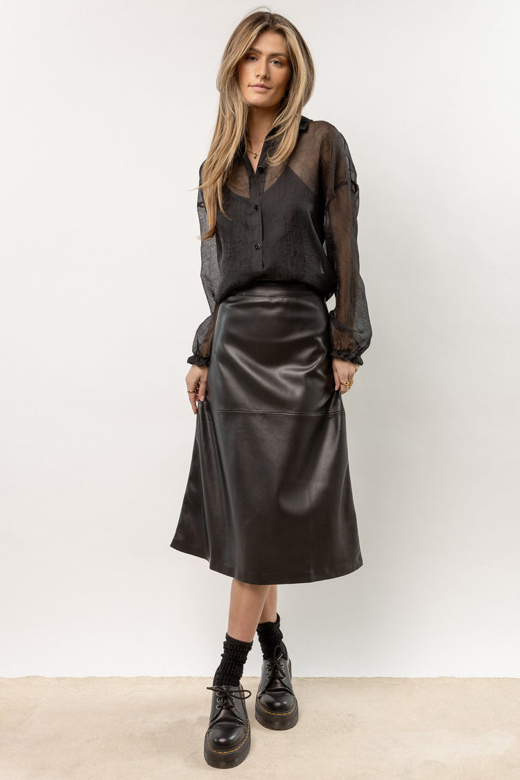 model wearing black leather midi skirt 