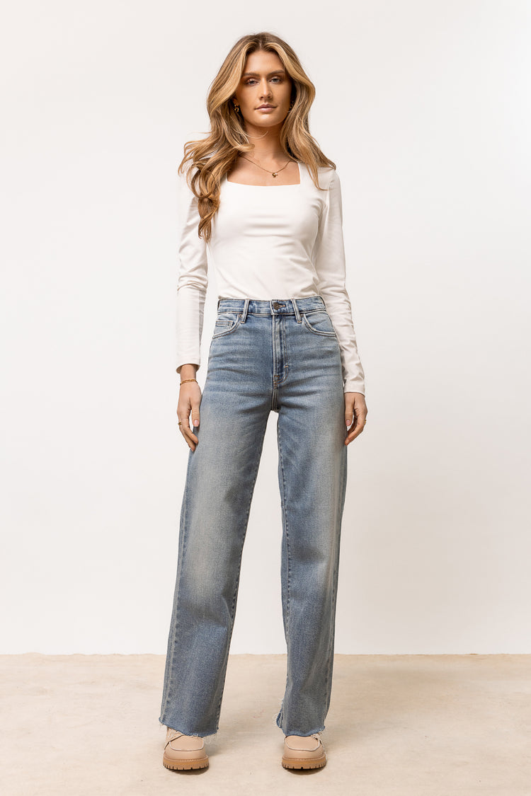 white llong sleeve bodysuit paired with wide leg denim