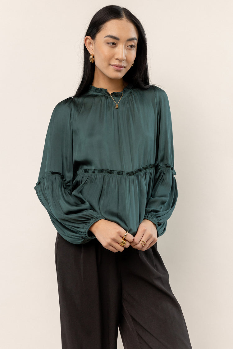 green blouse with ruffle detail
