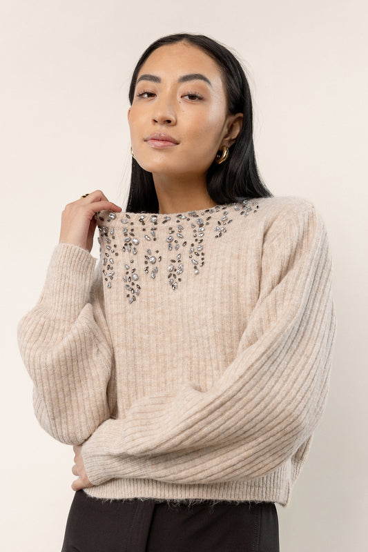cream colored sweater with jewel detail