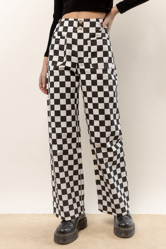 model is wearing black checker pants with black top