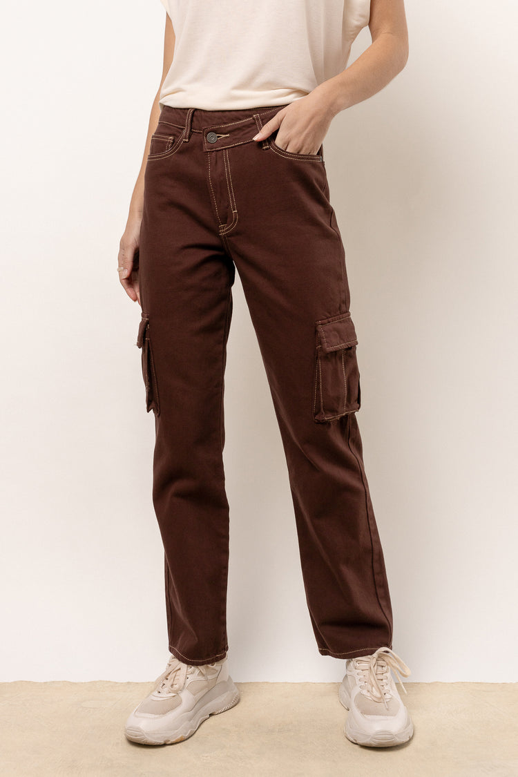 model is wearing brown cargo denim with white tee