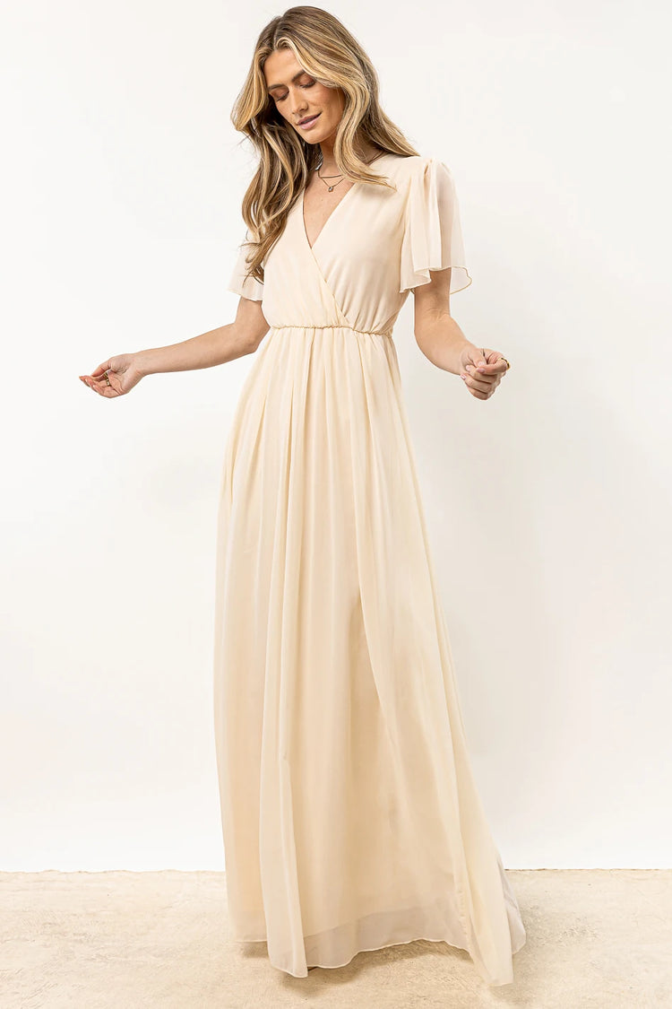cream dress with flutter sleeves