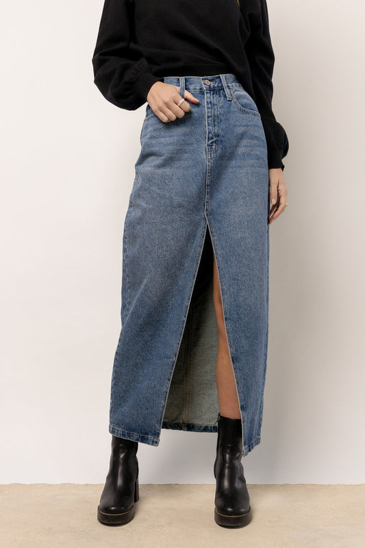 model is wearing denim maxi skirt with black boots