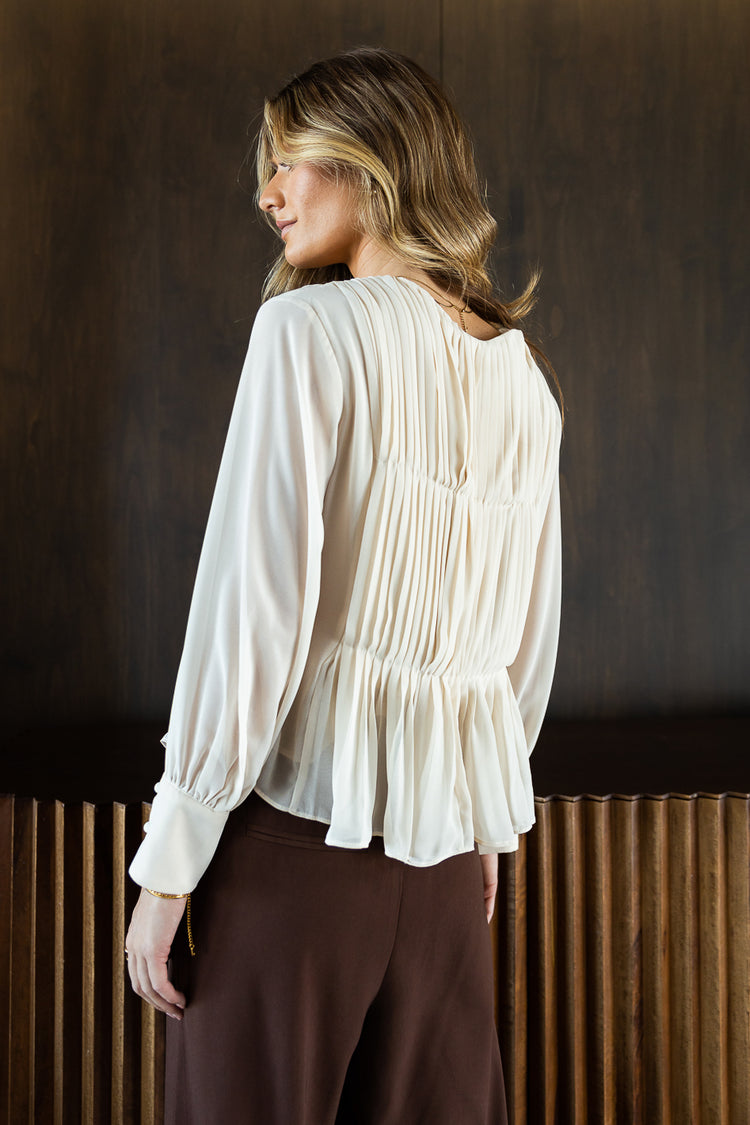 cream peplum blouse with long sleeves
