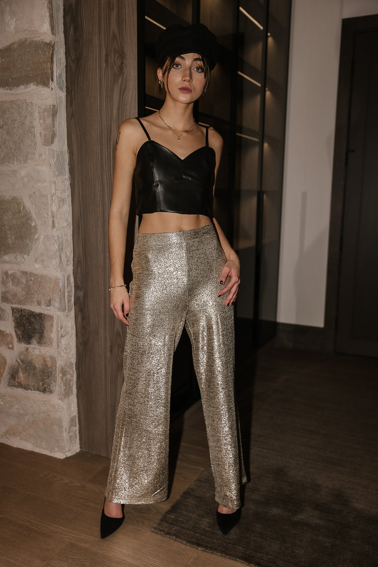 Glitter pants paired with a leather black top 