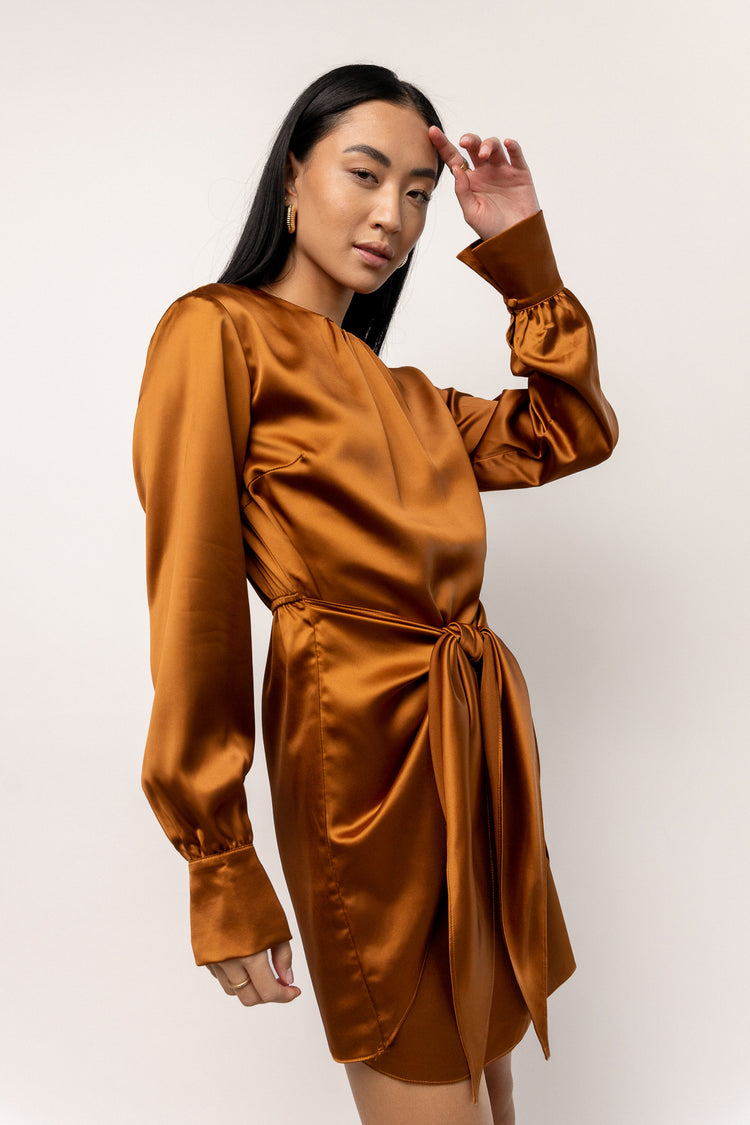 model wearing satin copper long sleeve mini dress 