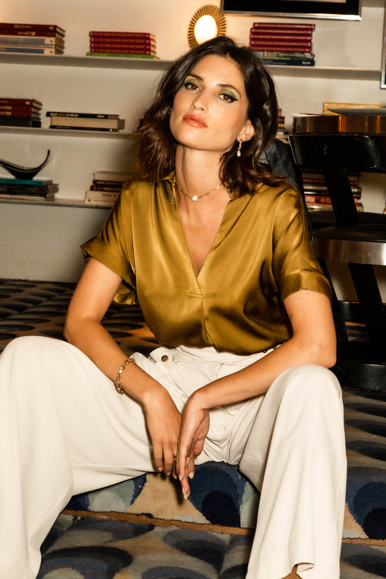 model wearing silk moss short sleeved v-neck paired with cream wide leg pants