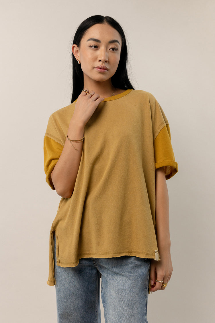 mustard colored t-shirt with raw hem