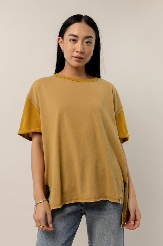 model wearing olive oversized short sleeve tee with rolled sleeve