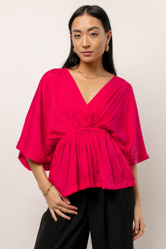pink blouse with deep V-neck
