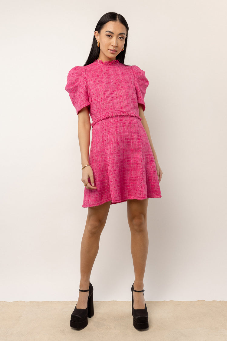 model wearing pink mini dress with short puff sleeves