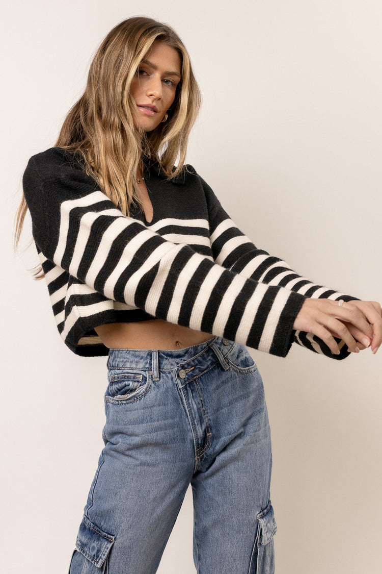 model is wearing long sleeve striped sweater with utility denim